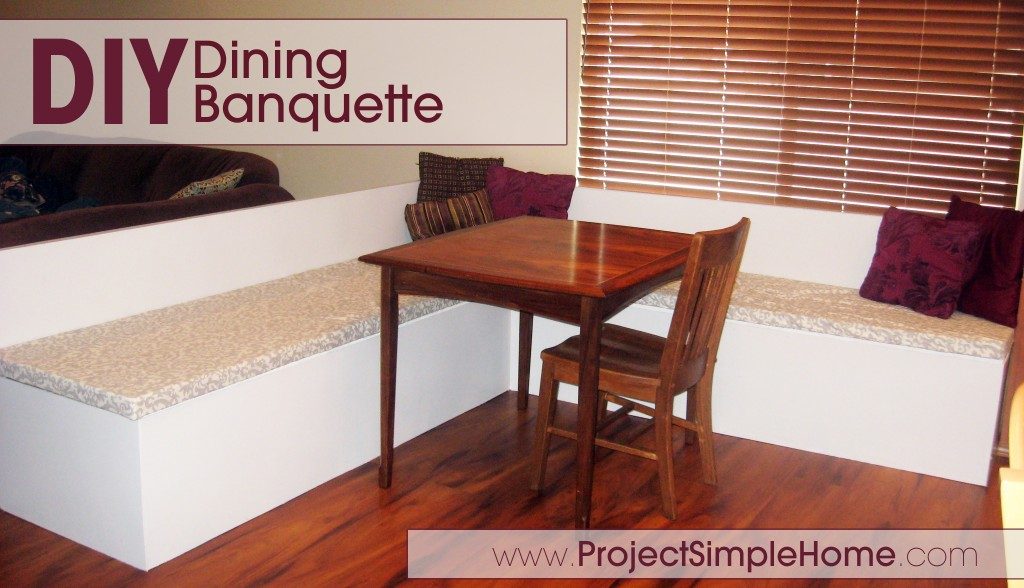 A white L-shaped dining banquette surrounding a wood table